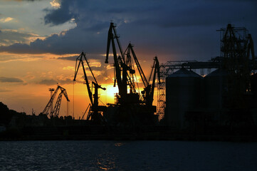Fototapeta na wymiar Sea port and industrial cranes, Odessa, Ukraine. Sunset