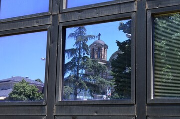 Serbian Orthodox Church in the window glass on a building in Belgrade