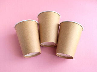 disposable paper cup on pink background. ecology, environmental pollution by plastic, waste recycling concept. flatlay