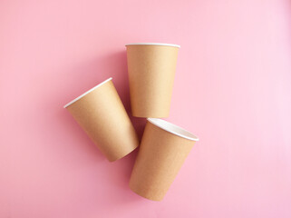 disposable paper cup on pink background. ecology, environmental pollution by plastic, waste recycling concept. copyspace