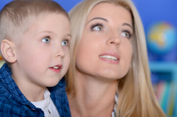 Portrait of mother and son posing at home