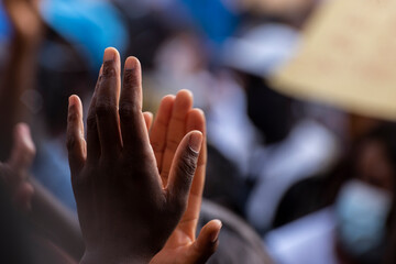 Close up of hands clapping in a crowd