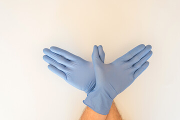 HANDS WITH SANITARY GLOVES FORMING A DOVE OF PEACE