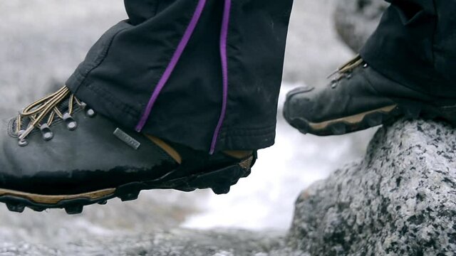 CU TS Man in hiking boots crossing stream / Tasermiut, Kujalleq, Greenland