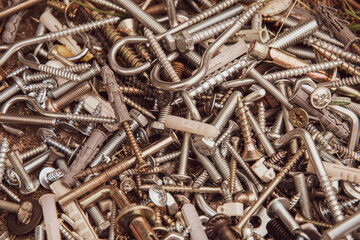 pile of rusty screws. Aged filter photo. Metal fastening manufacture. Hardware for repair or fixing