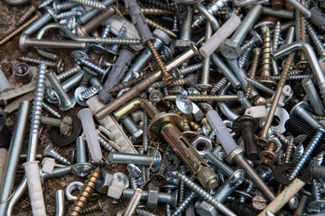 pile of nails and crews. Grunge steel and rusty metal fastening manufacture. Hardware for repair or fixing