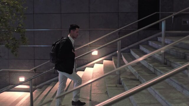 WS TS Businessman walking up steps in financial district / Milan, Italy