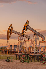 Petroleum concept. Oil pump rig. Oil and gas production. Oilfield site. Pump Jack are running....