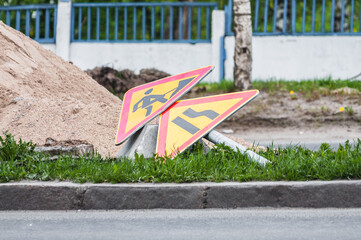 lying on the ground sign about roadworks