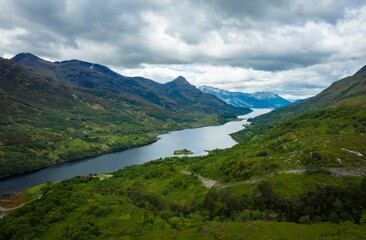 Fototapeta na wymiar a view over loch leven from the west highland way near kinlochleven and fort william in the argyll region of the highlands of scotland during a warm spring day showing green forest and hillsides