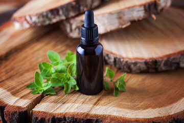 oregano essential oil and fresh leaves - beauty treatment - obrazy, fototapety, plakaty