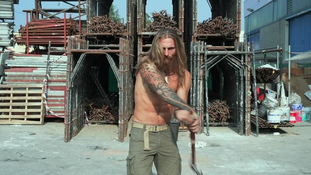 MS Man with axe on construction site / Mariano Comense, Como, Italy