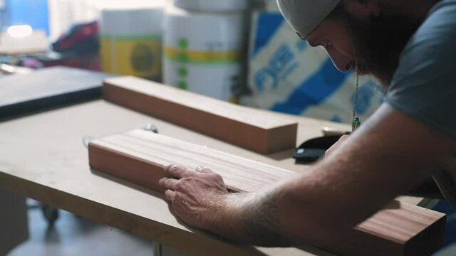 MS SELECTIVE FOCUS Carpenter drawing on wood in workshop / Mariano Comense, Como, Italy
