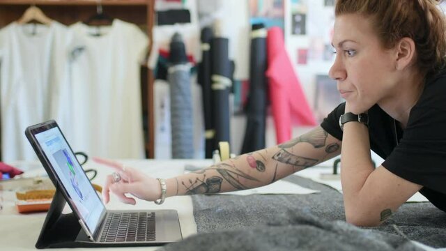 MS Woman using laptop in workshop / Milan, Italy