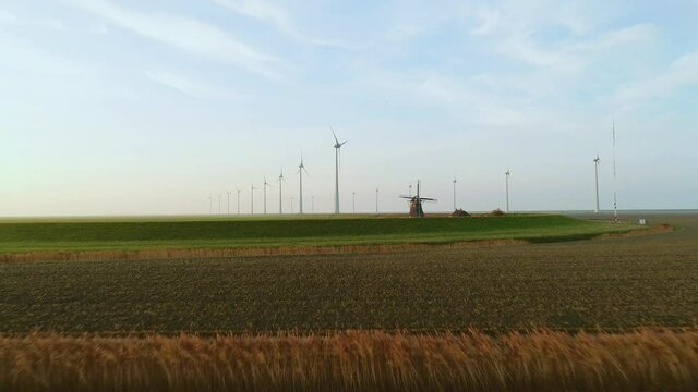 WS POV Historical windmill Goliath near wind turbines in Eemshaven harbor area / Delfzijl, Groningen, Netherlands