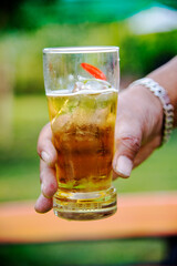 a man holding a glass of beer in his hand