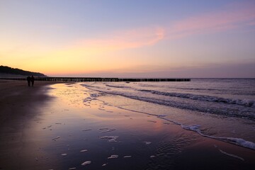 Beautiful sunset colors on the beach of sea and amazing reflection in water.