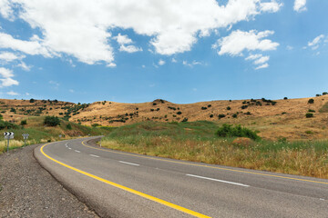 Road in the Golan Heights against the backdrop of beautiful clouds