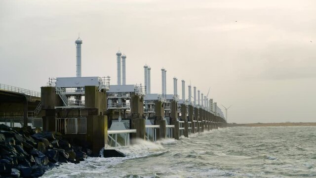 WS SLO MO Waves hitting Oosterscheldekering flood barrier on stormy day / Vrouwenpolder, Zeeland, Netherlands