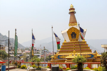 View of large beautiful gold colored biddhist stupa located in Amideva Buddha Park (also known as Buddha Garden) in the western part of Kathmandu city, Nepal. Religious architecture theme.