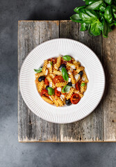 Pasta fusilli with cherry tomatoes, basil and olives. Homemade pasta 