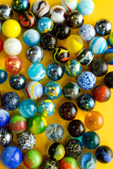 Colorful Marble Balls on Yellow background