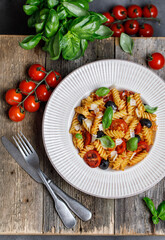 Pasta fusilli with cherry tomatoes, basil and olives. Homemade pasta 