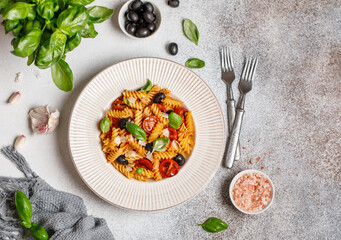 Pasta fusilli with cherry tomatoes, basil and olives. Homemade pasta 