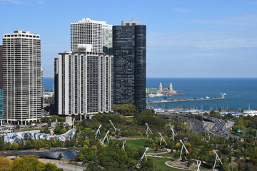 Tourists visiting Cloud Gate, one of the most unique and interesting sculptures in decades graces the promenade at Chicago Millennium Park.
