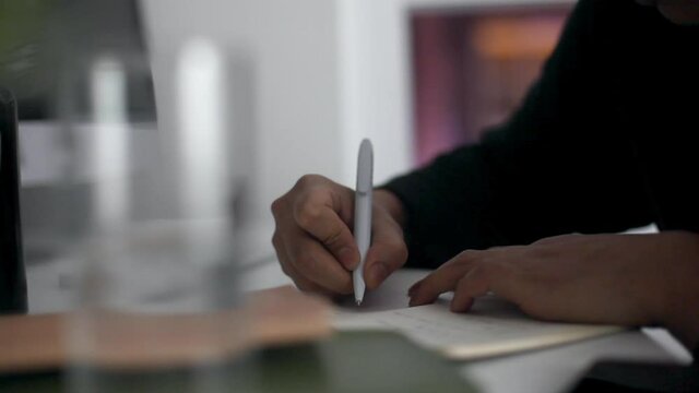 CU SELECTIVE FOCUS Man writing in note pad / Soho, London, England, United Kingdom