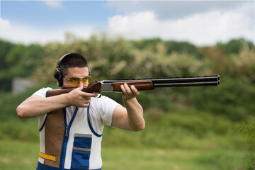 Man shooting on an outdoor shooting range