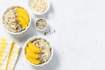 Oatmeal citrus porridge, healthy breakfast. Top view, copy space.