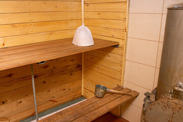 Bath accessories in the interior of the Russian bath. cap, wooden ladle on a background of a log walls in a Russian bath.