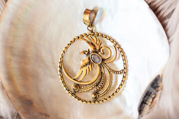 Brass pendant with Phoenix in round shape mandala on white shell background
