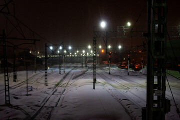Saratov / Russia. Winter in city streets. Night market. Train station in snowfall.