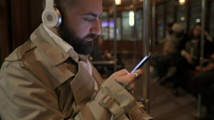CU Man sitting in cable car and using smart phone / Milan, Italy