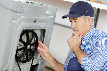 plumber with clipboard near washing machine