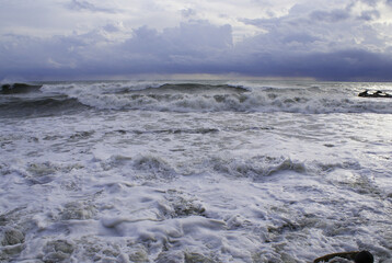 Storm, strong waves, sea coast, pebbles on the beach