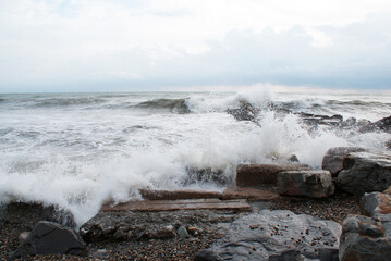 Sea, waves are breaking on stones, seashore