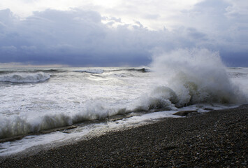 Storm, strong waves, sea coast, pebbles on the beach