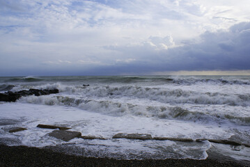 Fototapeta premium Storm, strong waves, sea coast, pebbles on the beach