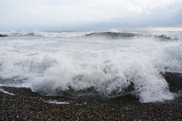 Storm, strong waves, sea coast, pebbles on the beach