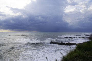Fototapeta na wymiar Storm, strong waves, sea coast, pebbles on the beach