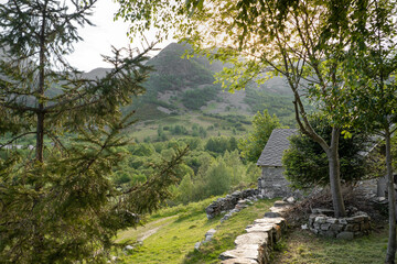 views from the cabin to the mountain with the sun between trees