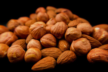 Almonds and hazelnuts. Nuts on a black background