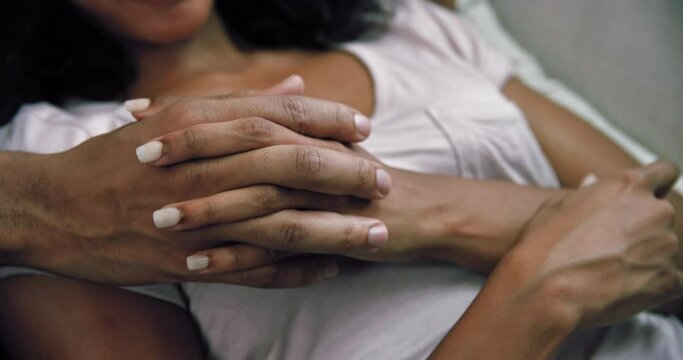CU TU Couple lying on sofa and holding hands / Claremont, Cape Town, South Africa