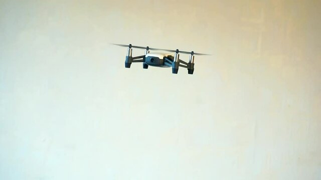 hobbies and entertainment.small four-engine drone flies indoors
