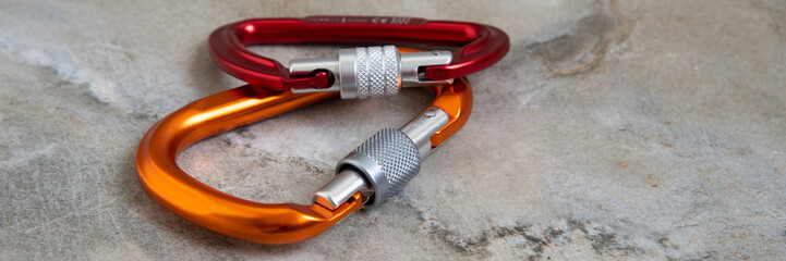 Screw gate carabiners on a marble top © plysuikvv
