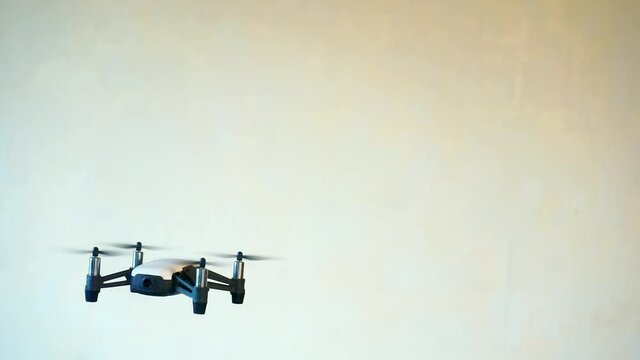 hobbies and entertainment.small four-engine drone flies indoors
