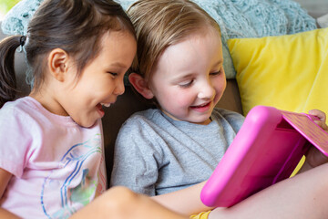 Children watching and playing educational videos and games. Learning at home.